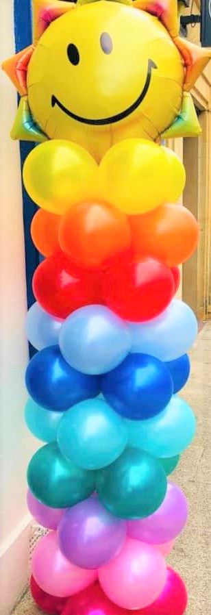 Rainbow balloon column with sunshine topper - The Ultimate Balloon & Party Shop
